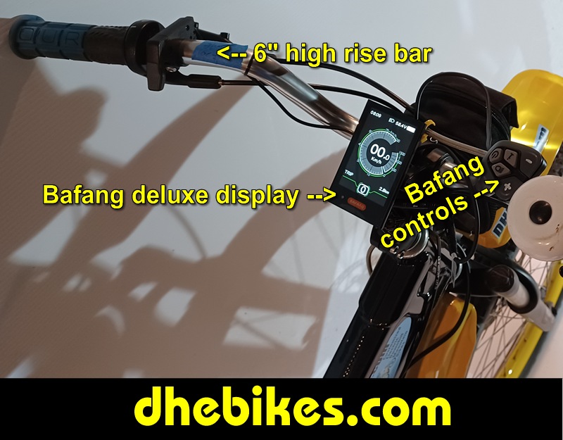 Custom made to order Womens electric downhill mountain bike by Pinnacle Innovations cockpit view showing the GripShift shifters, high rise bar and the Bafang 750 Watt mid mount electric motor throttle.
