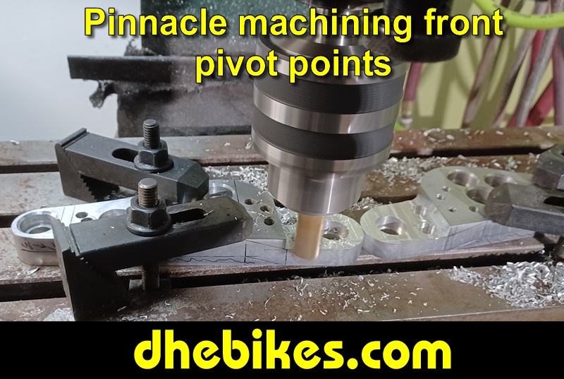 Pinnacle Innovations picture showing machining in progress of the rear pivot points for two Norco custom downhill bike's long travel rear suspension linkage plates made from 6061 aircraft aluminum.
