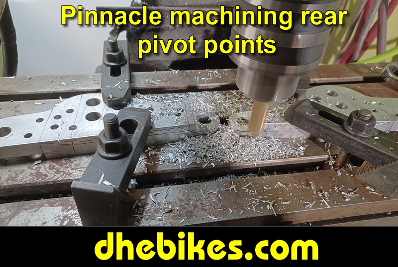 Pinnacle Innovations picture showing machining in progress of the rear pivot points for two Norco custom downhill bike's long travel rear suspension linkage plates made from 6061 aircraft aluminum.
